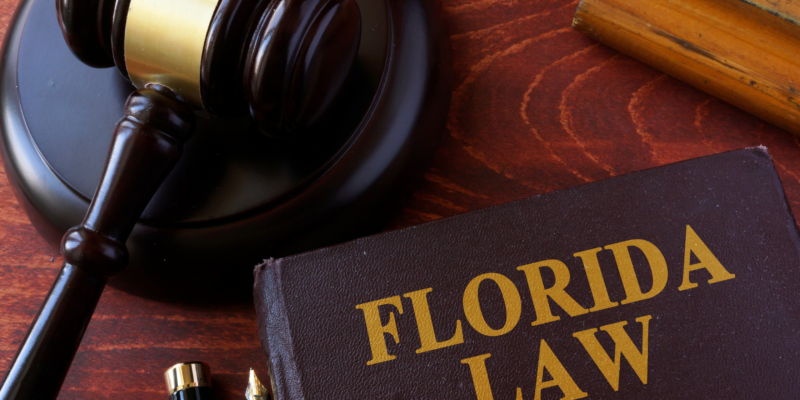 florida law book on a desk next to a gavel